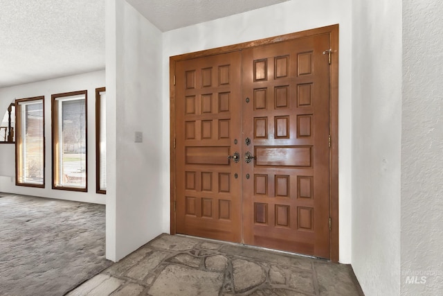 204 Hilldrop St, Caldwell, ID 83605 - carpeted foyer entrance with a textured wall and a textured ceiling