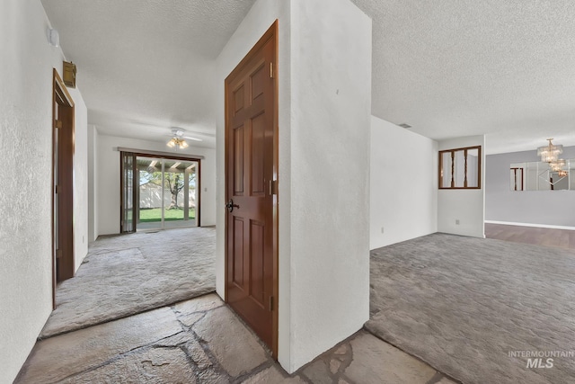 204 Hilldrop St, Caldwell, ID 83605 - interior space featuring a textured ceiling, carpet flooring, and an inviting chandelier