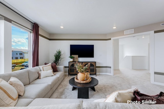 living area with light colored carpet, recessed lighting, and baseboards