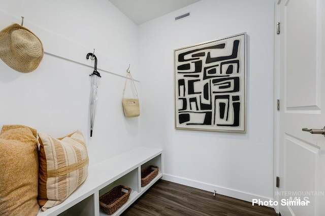 mudroom featuring dark wood finished floors and baseboards