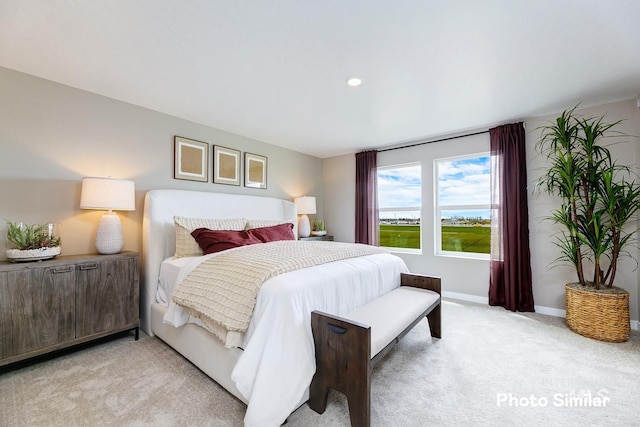 bedroom featuring light carpet, baseboards, and recessed lighting