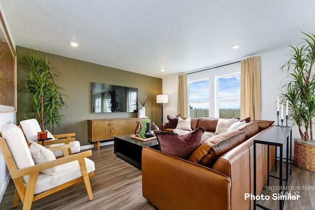 living area with wood finished floors, recessed lighting, and baseboards