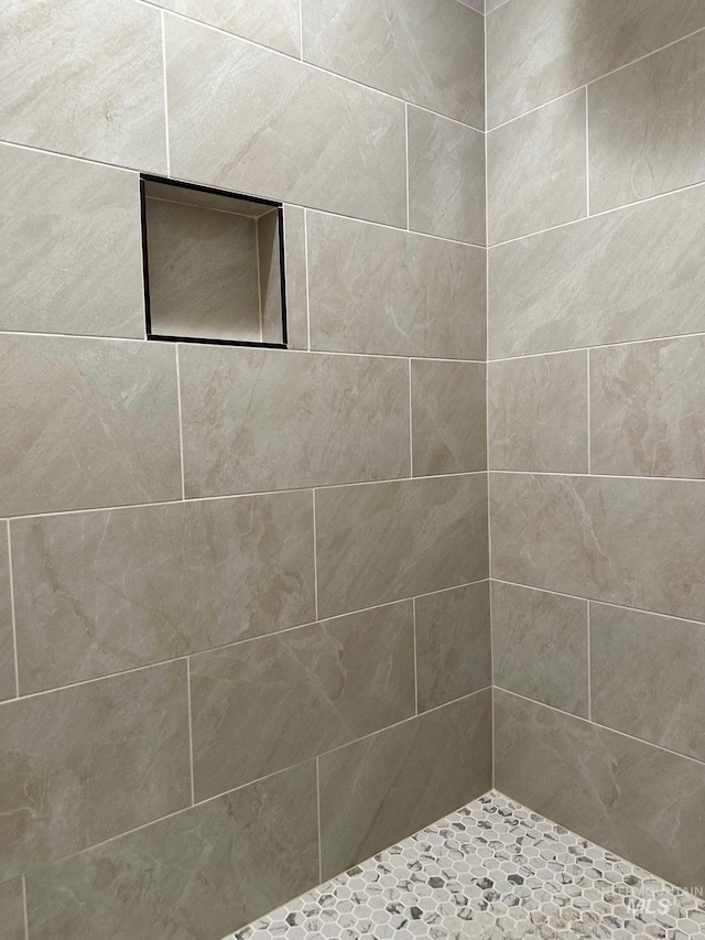 bathroom with tiled shower