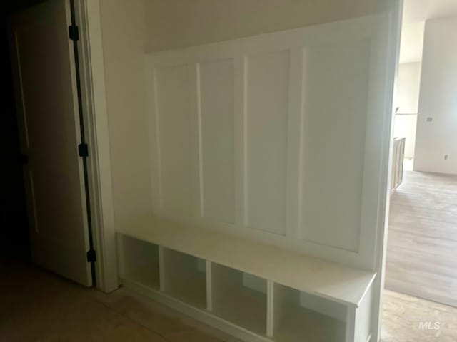 mudroom featuring a decorative wall