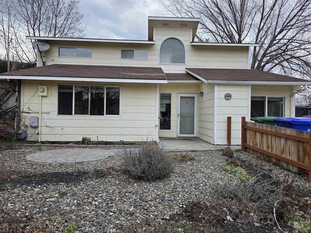 view of front of house featuring a patio area and fence