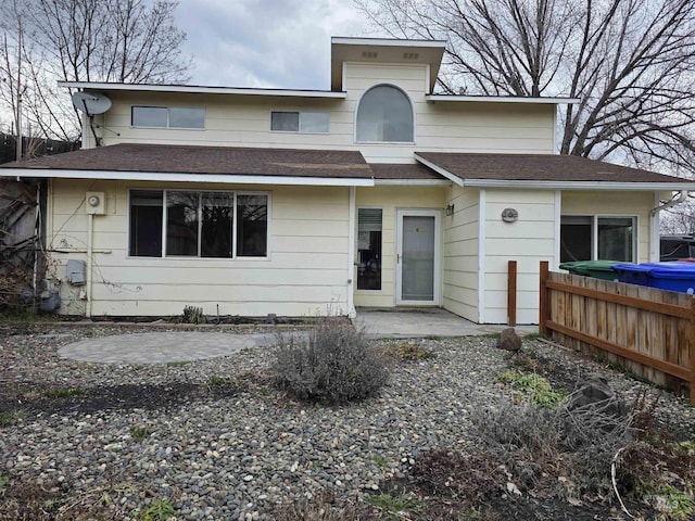 view of front of property with a patio area and fence