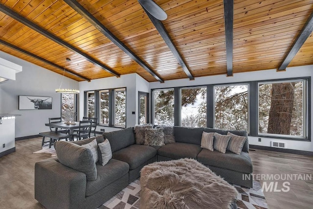 unfurnished living room featuring vaulted ceiling with beams, ceiling fan, wooden ceiling, and dark hardwood / wood-style floors