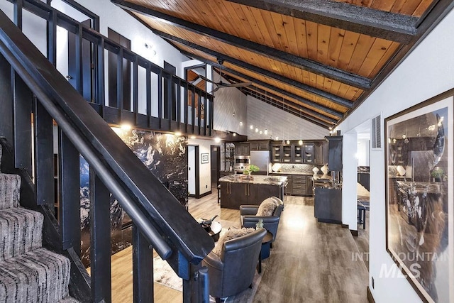 interior space with beam ceiling, light hardwood / wood-style floors, high vaulted ceiling, and wood ceiling