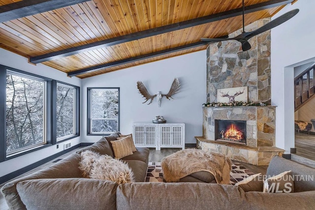 living room with wood ceiling, a stone fireplace, hardwood / wood-style floors, and lofted ceiling with beams