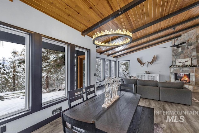 dining space featuring vaulted ceiling with beams, a wealth of natural light, hardwood / wood-style floors, and wooden ceiling