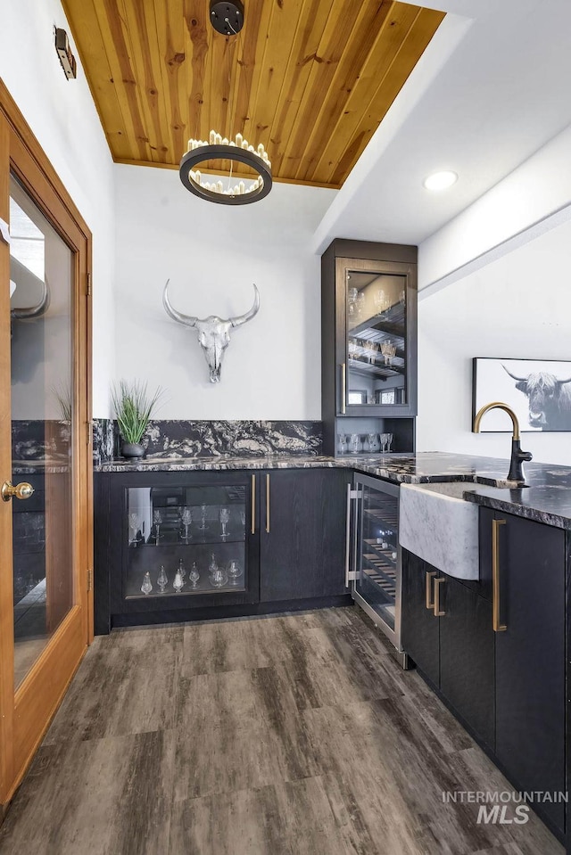 interior space with wooden ceiling, dark hardwood / wood-style flooring, beverage cooler, and sink