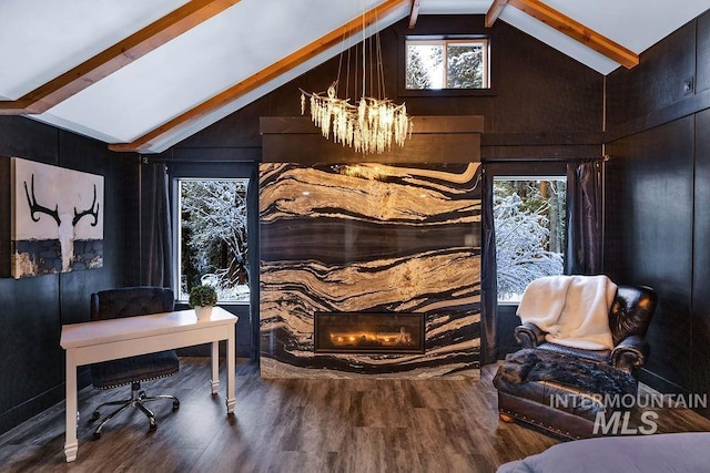 sitting room with a chandelier, hardwood / wood-style floors, and lofted ceiling with beams