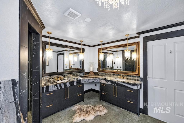 bathroom with vanity, a textured ceiling, tasteful backsplash, and ornamental molding