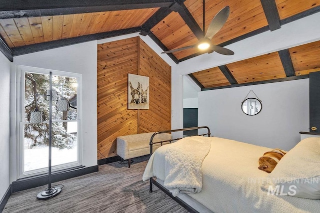 carpeted bedroom featuring lofted ceiling with beams, wooden ceiling, and wooden walls