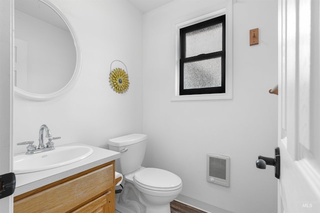 3224 Meadowlark, Lewiston, ID 83501 - half bath featuring vanity, toilet, heating unit, and baseboards