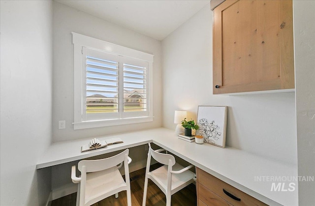 office space with built in desk and wood finished floors