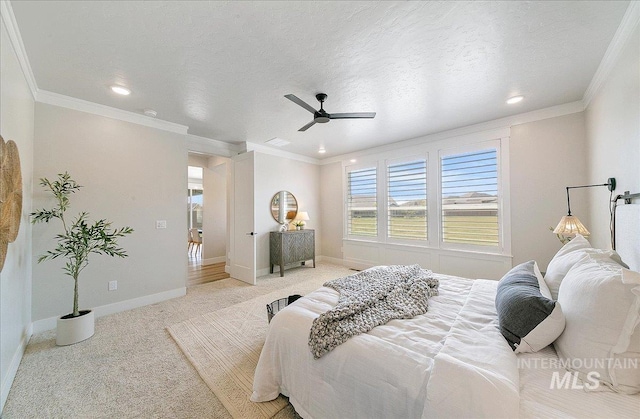 bedroom featuring baseboards, ornamental molding, light carpet, and recessed lighting