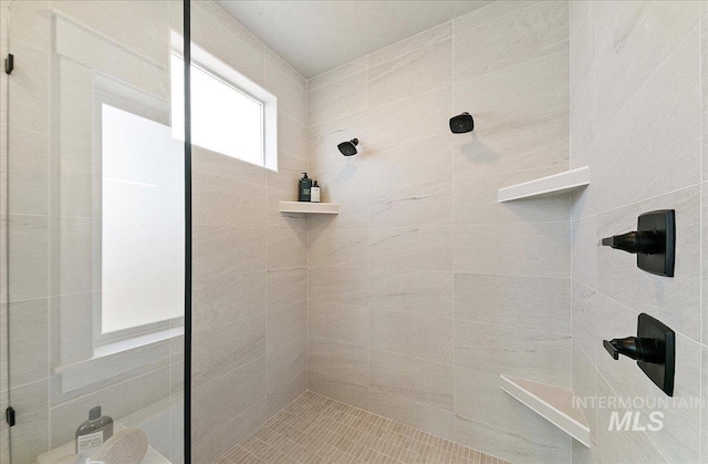 full bathroom with tiled shower