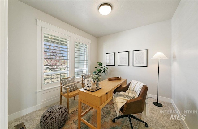 carpeted home office featuring baseboards and visible vents