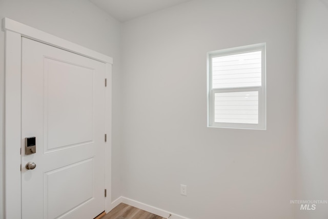 interior space featuring light wood-style flooring and baseboards