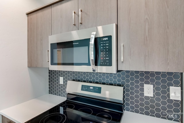 kitchen featuring light brown cabinets and appliances with stainless steel finishes