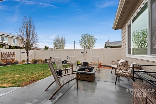view of patio / terrace featuring an outdoor fire pit and a fenced backyard