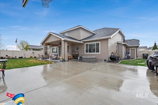 exterior space with cooling unit, a patio area, a front yard, and a fenced backyard