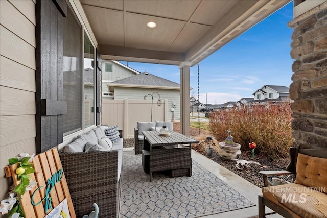 view of patio featuring outdoor lounge area and fence