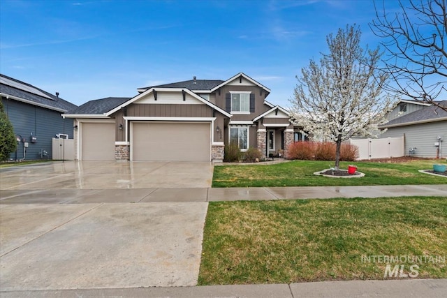 craftsman-style house with a garage, fence, concrete driveway, a front lawn, and a gate