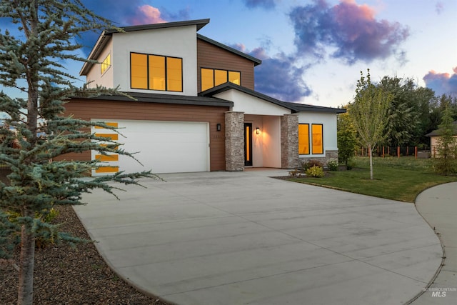 6536 W Flathead Lake St, Eagle, ID 83616 - contemporary house featuring stucco siding, stone siding, driveway, a garage, and a front yard