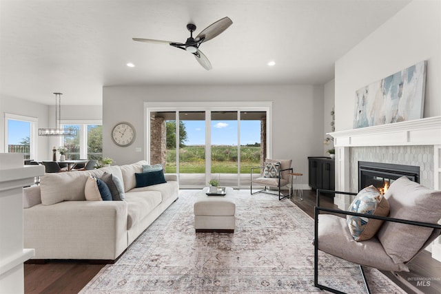 6536 W Flathead Lake St, Eagle, ID 83616 - living room featuring dark wood-style floors, a high end fireplace, healthy amount of natural light, recessed lighting, and a ceiling fan
