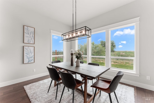 6536 W Flathead Lake St, Eagle, ID 83616 - dining room featuring healthy amount of natural light, a chandelier, and dark wood-type flooring
