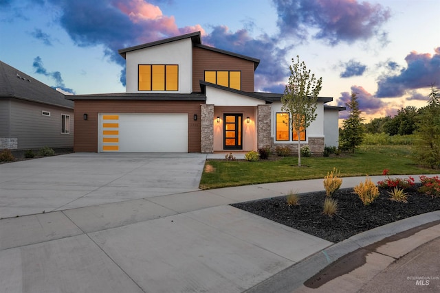 6536 W Flathead Lake St, Eagle, ID 83616 - contemporary home featuring stone siding, an attached garage, driveway, a yard, and stucco siding