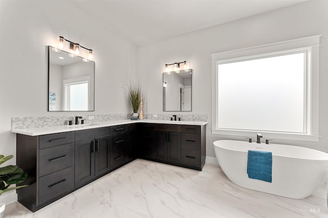 6536 W Flathead Lake St, Eagle, ID 83616 - bathroom with marble look tiles, double vanity, and a freestanding tub