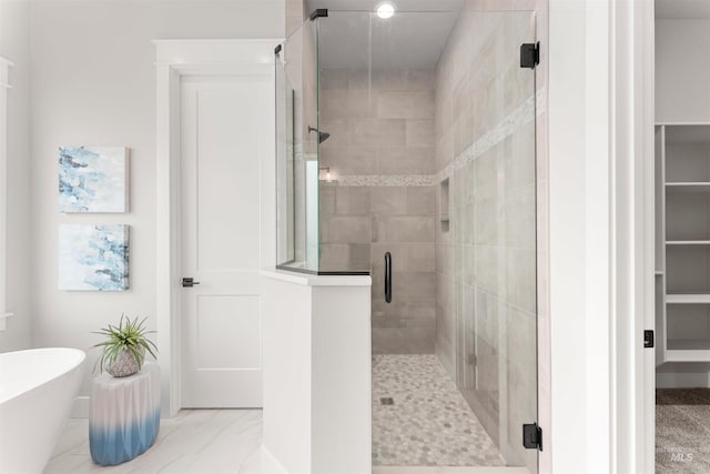 6536 W Flathead Lake St, Eagle, ID 83616 - full bathroom featuring a shower stall, a soaking tub, a spacious closet, and marble look tiles