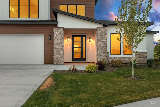 6536 W Flathead Lake St, Eagle, ID 83616 - contemporary house with stone siding, stucco siding, a garage, a yard, and concrete driveway