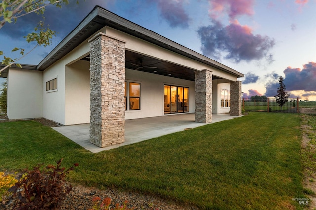 6536 W Flathead Lake St, Eagle, ID 83616 - rear view of house featuring stucco siding, a patio, and stone siding