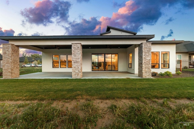6536 W Flathead Lake St, Eagle, ID 83616 - rear view of property featuring stucco siding, a patio area, a ceiling fan, and stone siding
