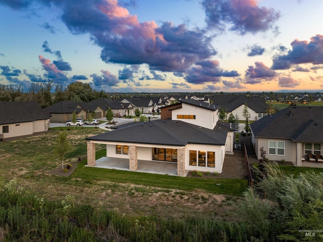 6536 W Flathead Lake St, Eagle, ID 83616 - view of front of property featuring a residential view, a patio area, a shingled roof, and a lawn