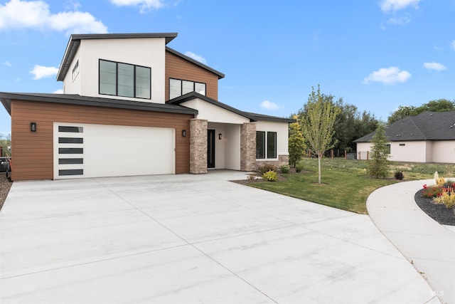 6536 W Flathead Lake St, Eagle, ID 83616 - contemporary house featuring a garage, driveway, a front yard, and stucco siding