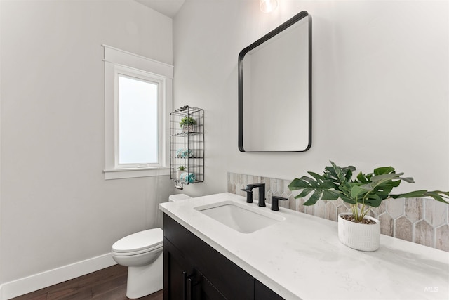 6536 W Flathead Lake St, Eagle, ID 83616 - bathroom with vanity, tasteful backsplash, and wood finished floors