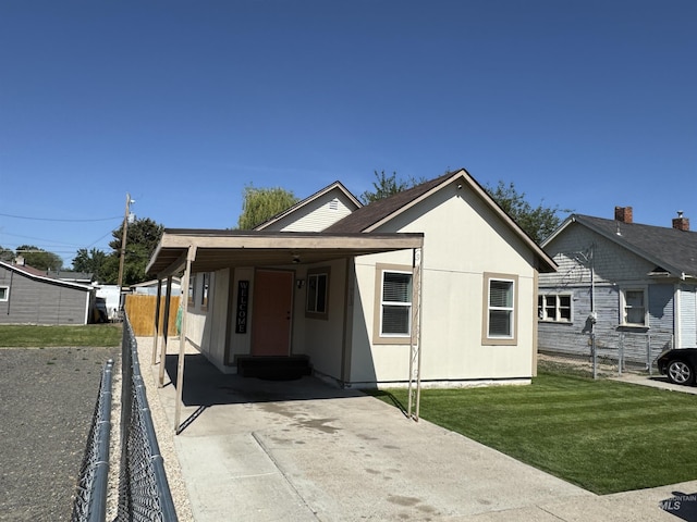 713 California St, Gooding, ID 83330 - view of front of house featuring a carport, driveway, and entry steps