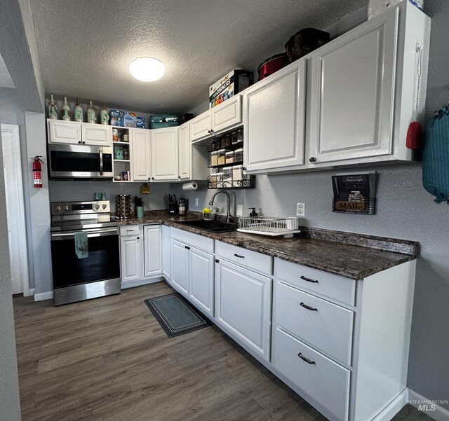 713 California St, Gooding, ID 83330 - kitchen with stainless steel appliances, a sink, a textured ceiling, white cabinets, and open shelves