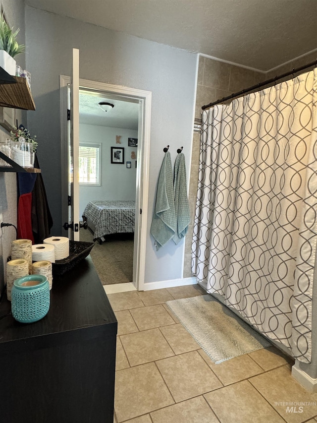 713 California St, Gooding, ID 83330 - ensuite bathroom with tile patterned flooring, curtained shower, and baseboards
