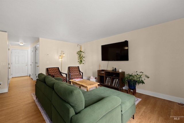 living room with baseboards and light wood finished floors