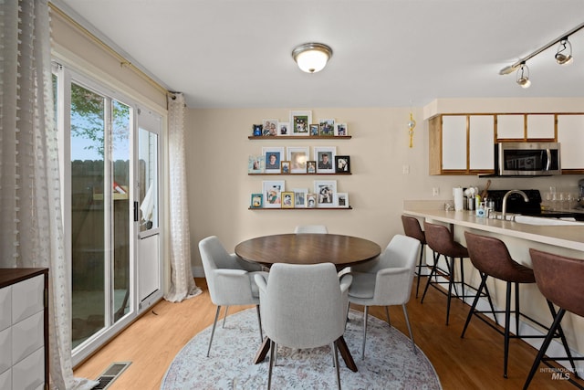 dining space with light wood-style floors
