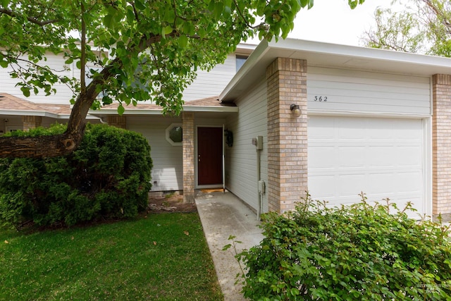 view of front of home featuring brick siding and a garage