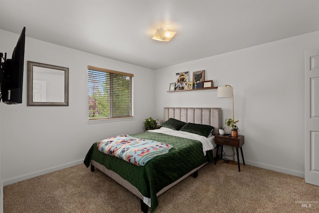 carpeted bedroom with baseboards