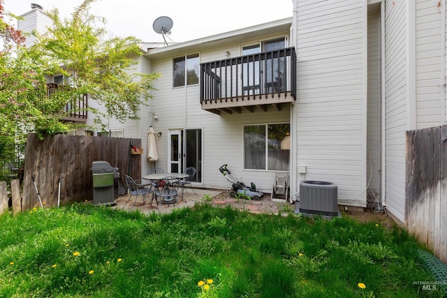 back of property with a patio, central AC unit, fence, and a balcony