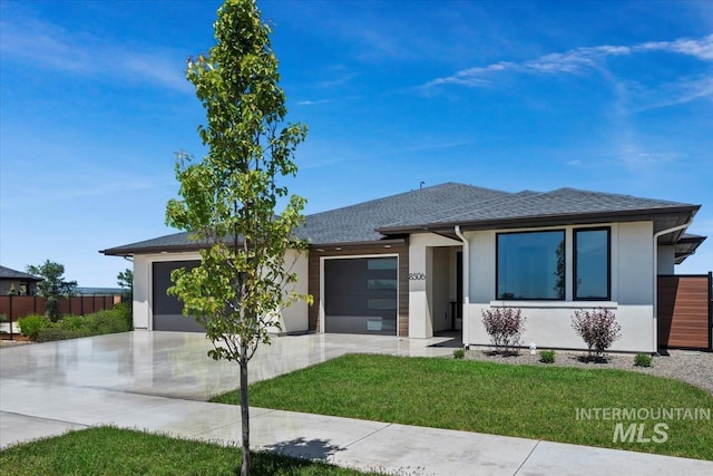 8506 W Graye St, Meridian, ID 83646 - view of front of house with an attached garage, driveway, stucco siding, and roof with shingles